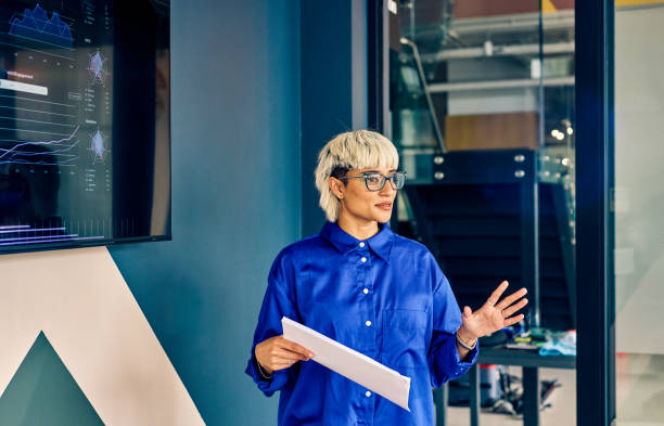 istock Professional Asian woman presenting data on a digital display in conference room. Effective communication and data visualization concept. 2153221944