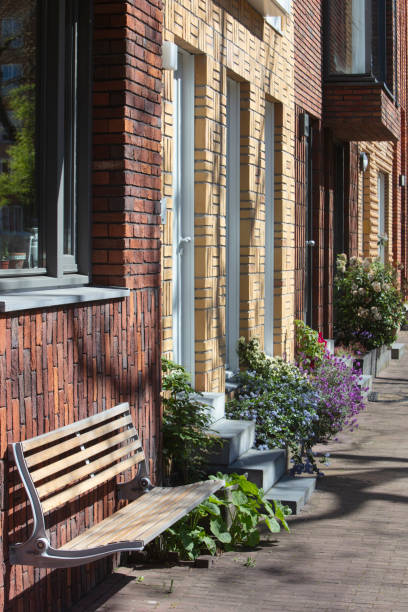 istock Street with apartments and a bench in the Netherlands 2153222011