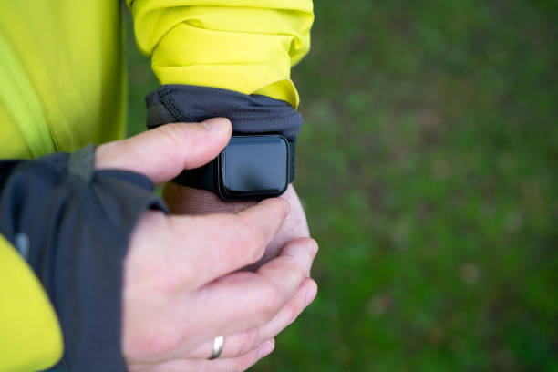 istock Smartwatches Screen mockup. Man checking activity data on smartwatch with blank black screen 2153223136