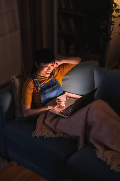 istock Woman relaxing at home late at night using laptop computer 2153223836