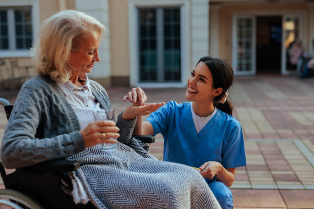istock Cheerful elderly woman taking medication in nursing home. 2153224165