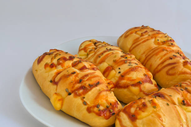 Fresh sausage cheese bread close up detail view with chili tomato sauce and white plain background