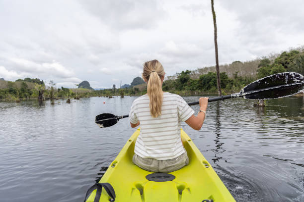 istock Woman Kayaking on Scenic Lake 2153227372