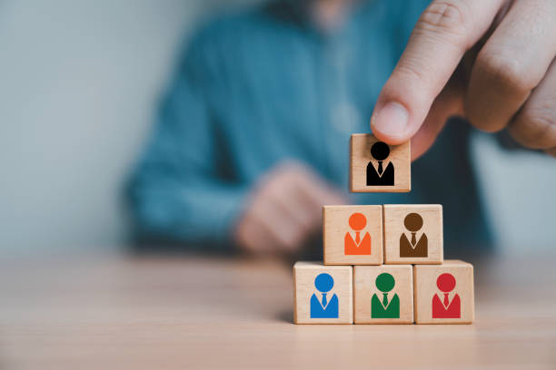 istock Businessman stacking human icon which print screen on wooden block cube for teamwork building by leadership and collaboration concept. 2153229903