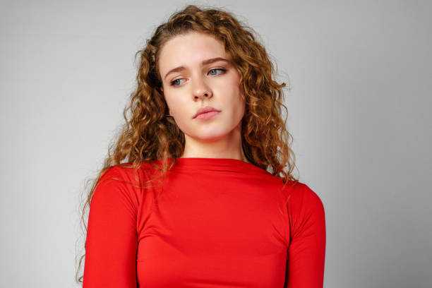 istock Young Woman With Curly Hair Expressing Concern 2153233958