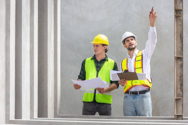 istock Engineer and foreman worker team checking project at precast concrete factory site, Engineer and builders in hardhats discussing on construction site 2153233968