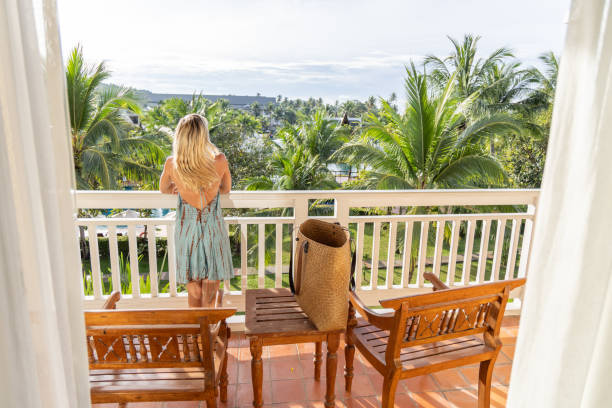 istock Woman Admiring Tropical View from Resort Balcony 2153237143