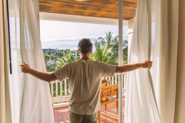 istock Man Embracing Morning View from Balcony 2153237210