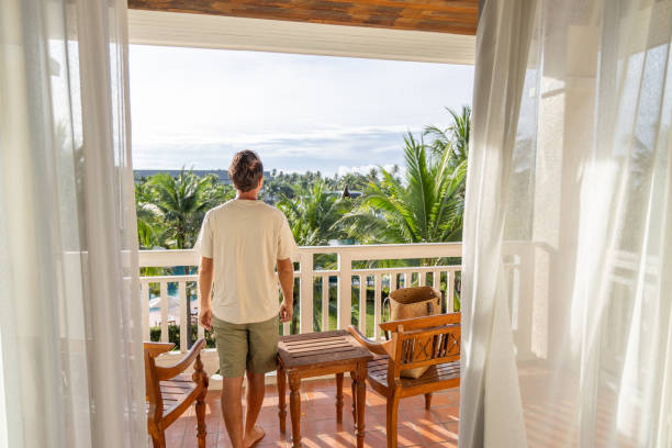 istock Man Standing on Balcony with Tropical View 2153237240