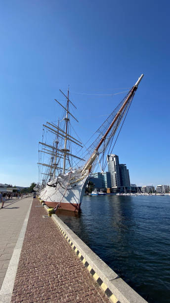 istock A majestic sailing ship docked at a modern harbor. Tall masts and rigging against a clear blue sky, combining tradition and modernity 2153239654