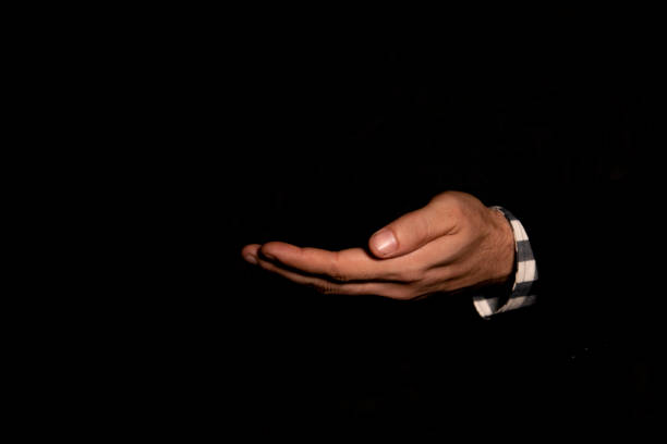 istock open hand of a white man,hand facing upward,blackbackgroud isolated in 2153241914