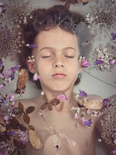 istock Boy lying underwater in bathtub with flowers 2153244534