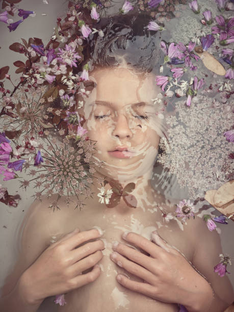 istock Boy lying underwater in bathtub with flowers 2153244648