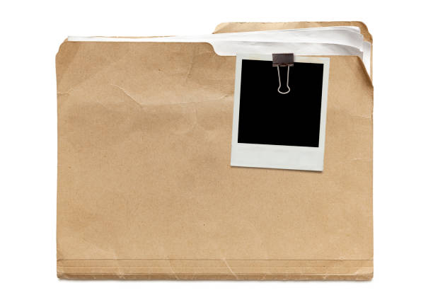 Old Manila Folder Old run-down manila folder with papers and attached instant photo isolated on white background manila folder and paper clip stock pictures, royalty-free photos & images