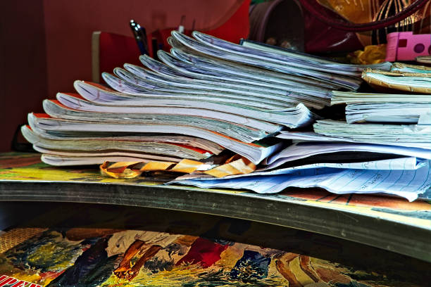 Organized notebooks and papers neatly stacked on shelves, displaying varying colors and textures, useful for education, office, or creative purposes.