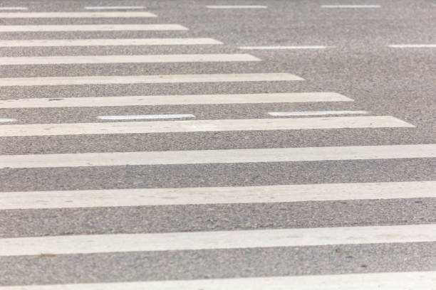 Pedestrian crossing on the road as a background.
