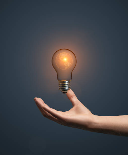 istock Artificial intelligence globe concept with hand holding classic light bulb glowing in the dark 2153253275