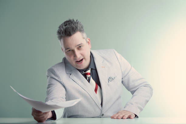 istock Charismatic presenter energetically discusses news, waves docume 2153257813