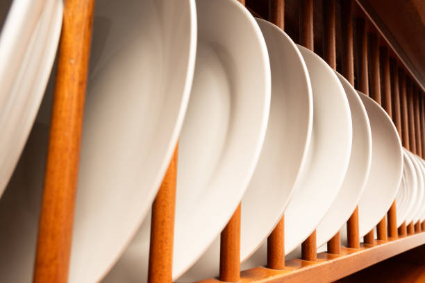 istock A wooden rack with many white plates on it 2153259174