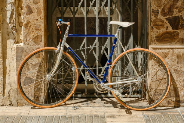 istock Old bicycle locked to a grate in the street. 2153259344