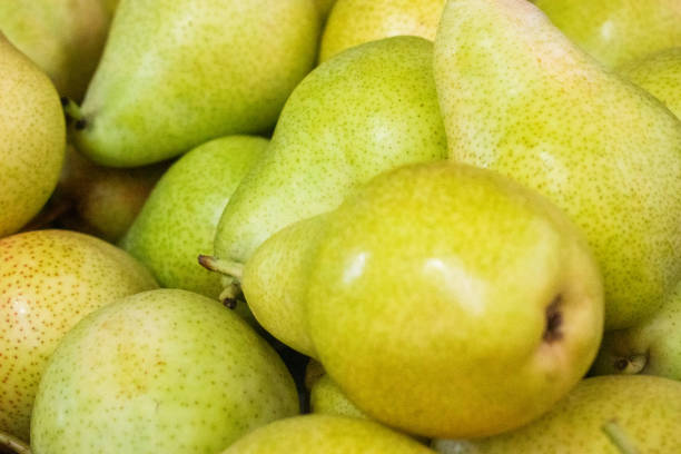 Ripe pears on a market stall. Close-up.