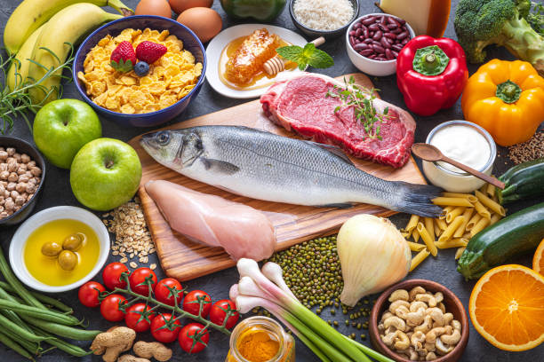Top view of a large group of healthy food for a balanced flexitarian diet. The composition includes dairy products, legumes, vegetables, fruits, cereals and various types of meats