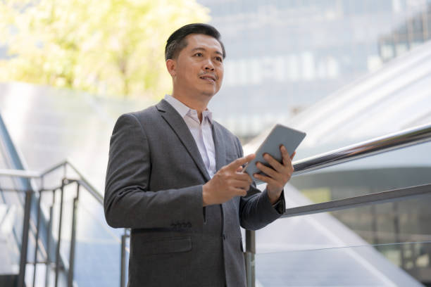 istock Professional businessman using tablet outdoors 2153266621