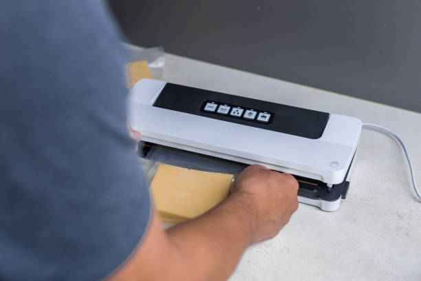 istock man vacuum-packing cheese with a vacuum cleaner 2153266861
