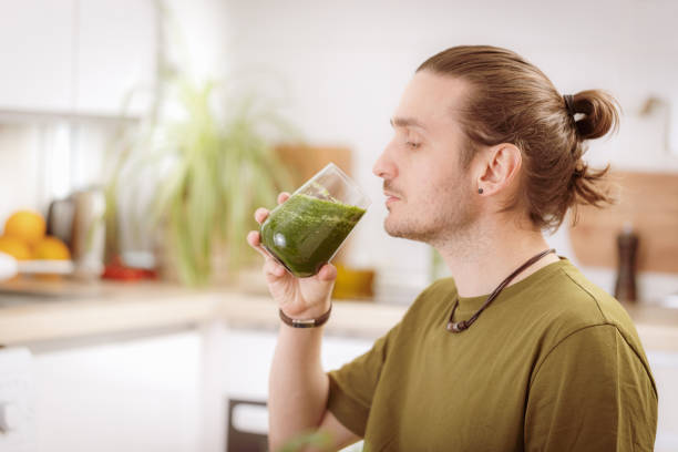 istock Young man drinking detox juice in the kitchen 2153267040