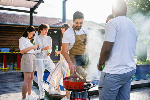 istock Friends having a barbecue party by the pool 2153269437