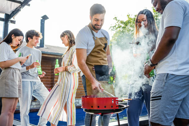 istock Friends having a barbecue party by the pool 2153271620