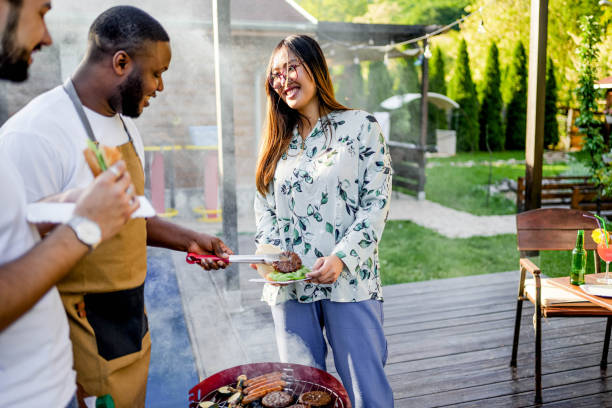 istock Young man barbecuing meat for friends 2153271727