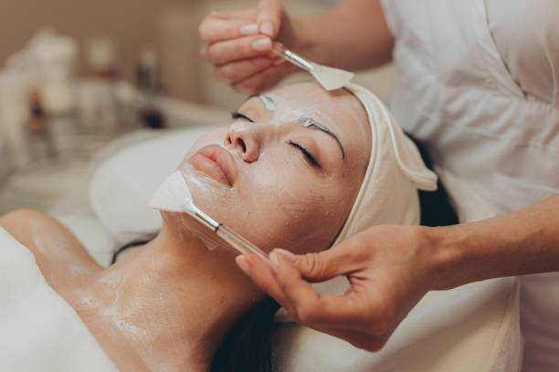 istock woman at the cosmetologist. She has problem skin and acne. 2153274849