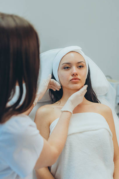istock girl at a cosmetologist's office doing skin cleansing 2153275053