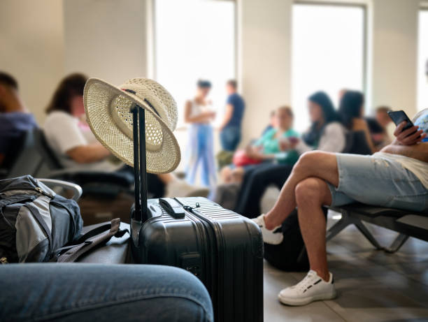 People and tourists walk with suitcases waiting for Check-in. Tourists ready to board the plane to leave and tourists arrived at destination get off the plane with suitcases in tow
