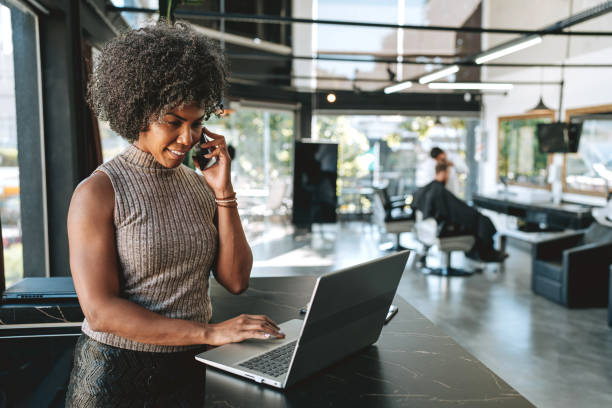 Barber shop receptionist portrait Barber shop receptionist portrait Black customer interacting with a business owner stock pictures, royalty-free photos & images