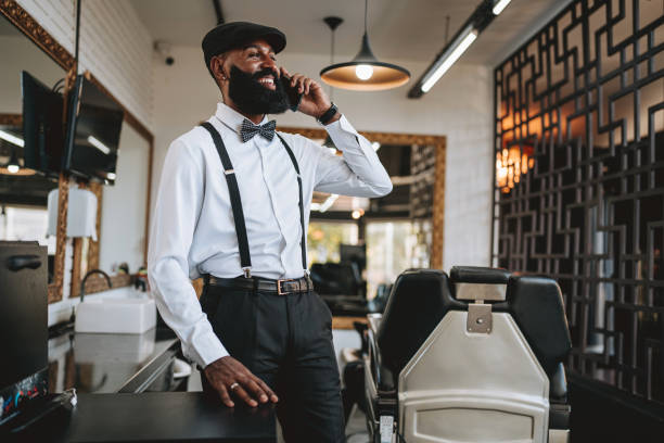 istock Portrait of a barber talking on smartphone 2153276400