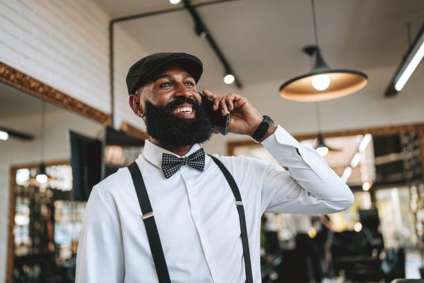 istock Portrait of a barber talking on smartphone 2153276410