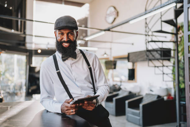 istock Portrait of a barber holding tablet 2153276436