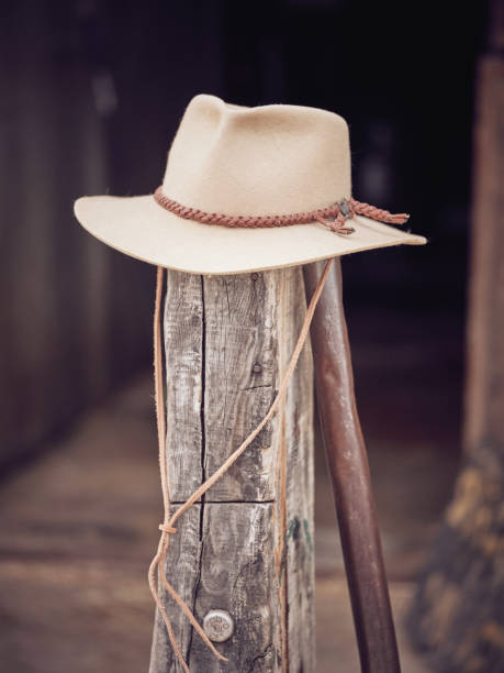 istock Cowboy hat on old wooden pillar 2153278091