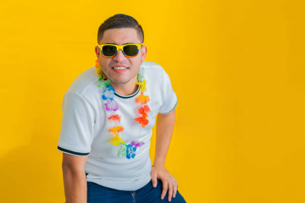 Cut out of a horizontal portrait of one happy smiling young 16 year old boy with smile on his face painted messy with Holi powder colours isolated over white background. Ideal for posters, greeting cards, postcards related to the Indian festival of colors - Holi. There is no text and ample copy space.