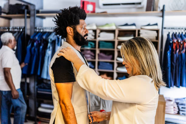 istock Tailor measuring a mature man for a new suit at the store 2153285897