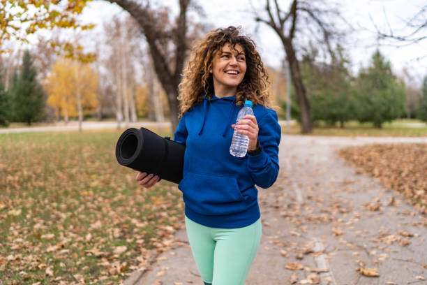 istock Fitness woman takes a refreshing break with fresh, cold water drinking 2153287457
