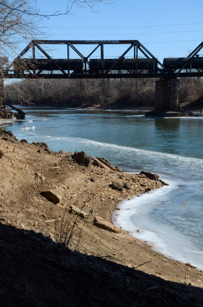 istock Trains in Snow - Train Crosses Icy Meramec River - Vertical 2153292442