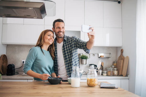 istock mature happy couple having breakfast at home 2153296139