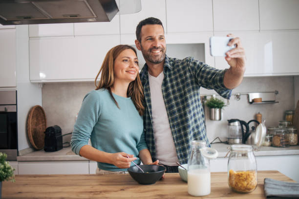 istock mature happy couple having breakfast at home 2153296317