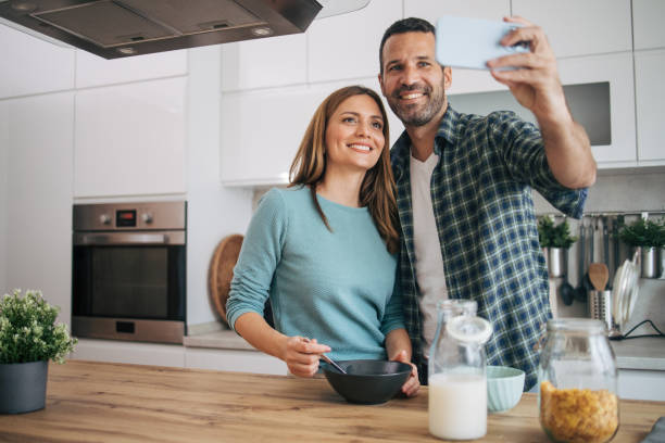 istock mature happy couple having breakfast at home 2153296357