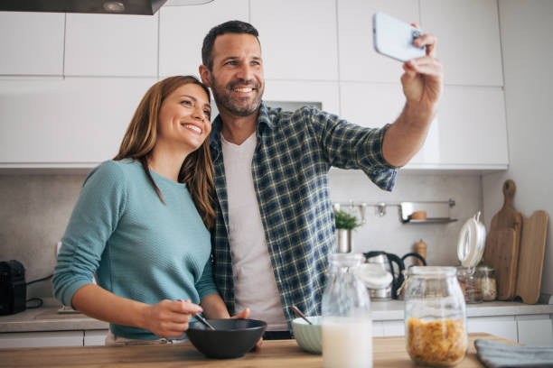 istock mature happy couple having breakfast at home 2153296374