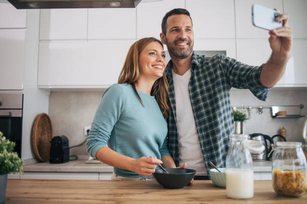 istock mature happy couple having breakfast at home 2153296375