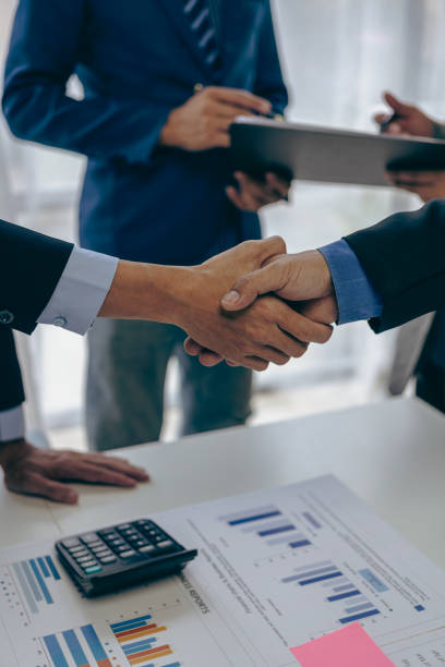istock Business people shaking hands and meeting with the above documents to hire a partner or work together at the office in recruiting. Teamwork or research of a close-up marketing projec 2153302177